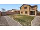 Two story home with drought resistant landscaping in a fenced backyard at 23619 W Harrison Dr, Buckeye, AZ 85326