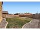 Fenced backyard featuring low maintenance desert landscaping at 23619 W Harrison Dr, Buckeye, AZ 85326