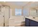 Bathroom showcasing a tub, shower, and a modern vanity with a sink at 23619 W Harrison Dr, Buckeye, AZ 85326