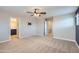 Large bedroom with an adjacent bathroom and a walk-in closet with carpet flooring at 23619 W Harrison Dr, Buckeye, AZ 85326