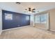 Spacious carpeted bedroom illuminated by three windows and equipped with ceiling fan at 23619 W Harrison Dr, Buckeye, AZ 85326