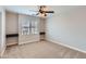 This bedroom features carpet floors, a ceiling fan, and dual built-in shelves at 23619 W Harrison Dr, Buckeye, AZ 85326