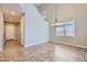Dining room featuring tile flooring, a decorative chandelier, and high ceilings at 23619 W Harrison Dr, Buckeye, AZ 85326