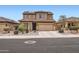 Two-story home featuring a tile roof, desert landscaping, and a two-car garage at 23619 W Harrison Dr, Buckeye, AZ 85326