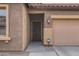 Close-up of the front door and garage, featuring a Ring doorbell and house number at 23619 W Harrison Dr, Buckeye, AZ 85326