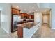 Modern kitchen featuring stainless steel appliances, a large island, and tile floors at 23619 W Harrison Dr, Buckeye, AZ 85326