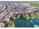 Aerial view of a residential community with lush landscaping, a pond with a fountain, and golf course nearby at 24822 S Sedona Dr, Sun Lakes, AZ 85248