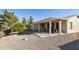 Spacious backyard with a covered patio area, low-maintenance gravel landscaping, and mature trees at 24822 S Sedona Dr, Sun Lakes, AZ 85248