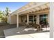 Covered patio with an outdoor dining and sitting area, overlooking desert landscaping at 24822 S Sedona Dr, Sun Lakes, AZ 85248