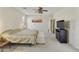 Large bedroom featuring neutral carpet and walls, a ceiling fan, and a decorative painting at 24822 S Sedona Dr, Sun Lakes, AZ 85248