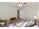 Well-lit bedroom featuring bed with a colorful patterned bedspread, ceiling fan, and closet at 24822 S Sedona Dr, Sun Lakes, AZ 85248