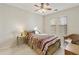 Comfortable bedroom with a ceiling fan, two windows, and a brightly patterned bedspread at 24822 S Sedona Dr, Sun Lakes, AZ 85248
