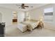 Spacious bedroom featuring neutral walls and carpet, a ceiling fan, and an attached bathroom entrance at 24822 S Sedona Dr, Sun Lakes, AZ 85248