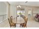 Cozy dining room with wood table, chairs, and view to outdoor covered patio at 24822 S Sedona Dr, Sun Lakes, AZ 85248