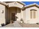 Close-up of the home's inviting front entrance, featuring desert landscaping and a secure front door at 24822 S Sedona Dr, Sun Lakes, AZ 85248