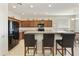 Spacious kitchen with wood cabinets, granite countertops, black appliances, and a breakfast bar with seating at 24822 S Sedona Dr, Sun Lakes, AZ 85248