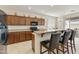 Bright kitchen featuring wood cabinets, stainless steel refrigerator, granite countertops, and breakfast bar at 24822 S Sedona Dr, Sun Lakes, AZ 85248