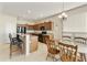 Spacious kitchen featuring wooden cabinetry, granite countertops, an island with bar seating, and modern appliances at 24822 S Sedona Dr, Sun Lakes, AZ 85248