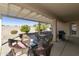 Relaxing covered patio with comfortable wicker furniture, a table, and views of the backyard at 24822 S Sedona Dr, Sun Lakes, AZ 85248