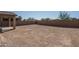 An empty, sunny backyard with a cinder block fence, ready for landscaping at 25930 N Thornhill Dr, Peoria, AZ 85383