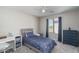 Comfortable bedroom with a gray bed frame, blue bedding, and a view of the outdoors at 25930 N Thornhill Dr, Peoria, AZ 85383