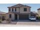 Charming two-story home featuring a tile roof, three-car garage, and desert landscaping at 25930 N Thornhill Dr, Peoria, AZ 85383