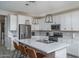 Bright kitchen featuring white cabinets, stainless steel appliances, and a large island with bar seating at 25930 N Thornhill Dr, Peoria, AZ 85383