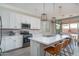 Bright kitchen featuring white cabinets, stainless steel appliances, and a large island with bar seating at 25930 N Thornhill Dr, Peoria, AZ 85383