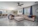 Spacious living room featuring luxury flooring and a large sectional sofa with backyard access at 25930 N Thornhill Dr, Peoria, AZ 85383