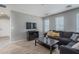 Cozy living room with a large sectional sofa, media console, and lots of natural light at 25930 N Thornhill Dr, Peoria, AZ 85383