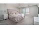 Serene main bedroom with a tufted headboard, plush carpeting, and soft lighting at 25930 N Thornhill Dr, Peoria, AZ 85383
