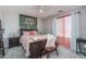 Cozy main bedroom with a wood bed frame, decorative wall art, and soft natural light at 25930 N Thornhill Dr, Peoria, AZ 85383