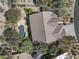A private backyard featuring a sparkling pool, lush landscaping, and a well-maintained tile roof at 28604 N 92Nd Pl, Scottsdale, AZ 85262