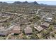 An aerial view showcasing the community, mountain views, and the surrounding desert landscape at 28604 N 92Nd Pl, Scottsdale, AZ 85262