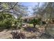 Landscaped backyard with a dry stream bed and mature desert trees at 28604 N 92Nd Pl, Scottsdale, AZ 85262