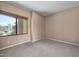 Cozy bedroom with carpeted floors, a window with bamboo shades, and neutral wall paint at 28604 N 92Nd Pl, Scottsdale, AZ 85262