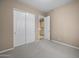This carpeted bedroom offers closet space and leads to another room at 28604 N 92Nd Pl, Scottsdale, AZ 85262