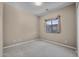 Neutral bedroom with a large window providing ample natural light and plush carpeting at 28604 N 92Nd Pl, Scottsdale, AZ 85262