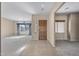 Inviting foyer with tile flooring leading to a carpeted living space and a decorative wood front door at 28604 N 92Nd Pl, Scottsdale, AZ 85262