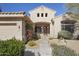 Welcoming front entrance with desert landscaping and a secure screen door at 28604 N 92Nd Pl, Scottsdale, AZ 85262