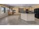 Open kitchen with tile floors, wood cabinetry, and granite countertops, ideal for cooking and entertaining at 28604 N 92Nd Pl, Scottsdale, AZ 85262