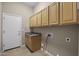 Convenient laundry room with ample cabinet storage, sink, and utility connections at 28604 N 92Nd Pl, Scottsdale, AZ 85262