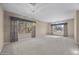 Spacious carpeted living room with large windows offering beautiful outdoor views and a decorative chandelier at 28604 N 92Nd Pl, Scottsdale, AZ 85262