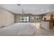 Spacious living room featuring plush carpeting, ceiling fan, and natural light from sliding glass door at 28604 N 92Nd Pl, Scottsdale, AZ 85262