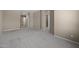 Expansive carpeted living room with neutral-toned walls, offering ample open space at 28604 N 92Nd Pl, Scottsdale, AZ 85262