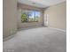 Spacious living room featuring neutral walls, carpet, and a large window at 28604 N 92Nd Pl, Scottsdale, AZ 85262