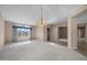 Bright living room with carpeted floors, large windows, and a stylish chandelier at 28604 N 92Nd Pl, Scottsdale, AZ 85262