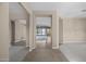 Open living area with tiled floors and plush carpeting, leading to sliding glass doors at 28604 N 92Nd Pl, Scottsdale, AZ 85262