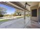 Covered patio with ceiling fan overlooks a backyard oasis, complete with a pool and beautiful desert landscaping at 28604 N 92Nd Pl, Scottsdale, AZ 85262
