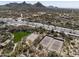 The community features tennis courts, lush green spaces, and desert landscaping with mountain views at 28604 N 92Nd Pl, Scottsdale, AZ 85262